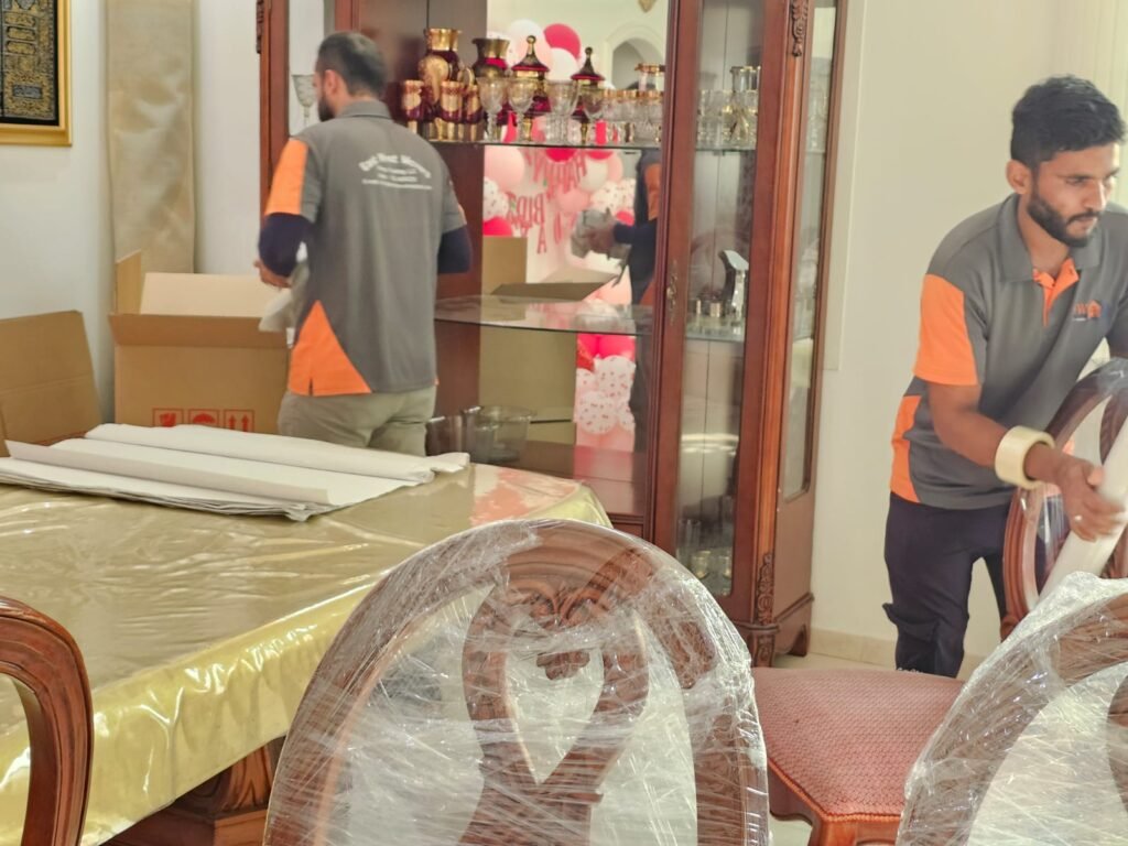 Professional local movers in Dubai packing household furniture